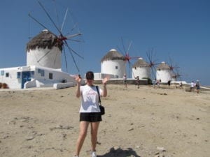 Nancy posing by the famous windmills in Mykonos, Greece