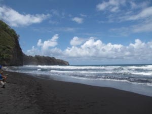 Enjoying the scenery at the black sand beach in Pololu Valley on the Big Island in Hawaii
