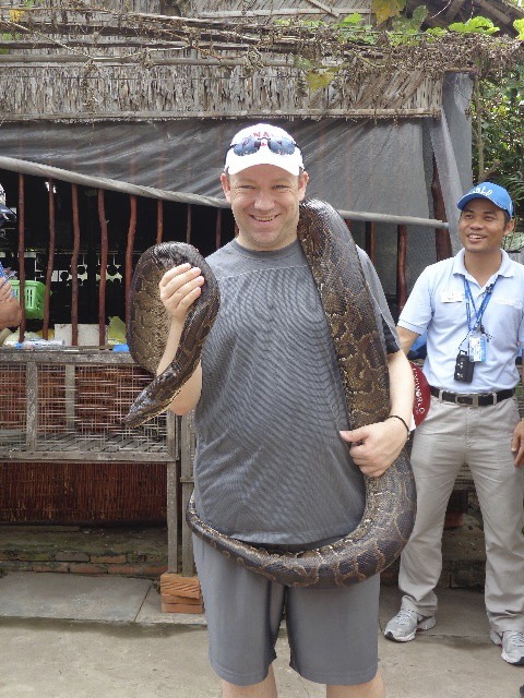 Holding a snake on tour with Uniworld River Cruises